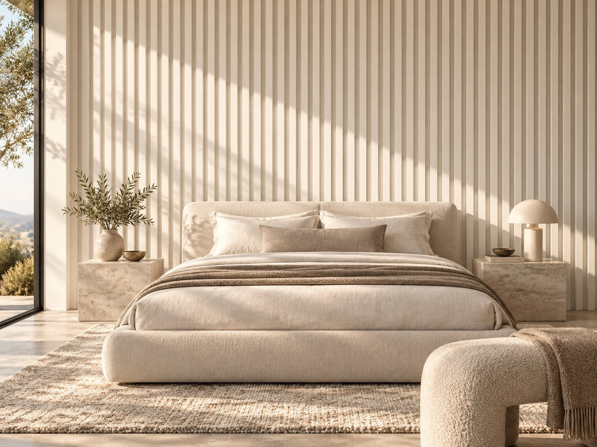 Bedroom with cream grooved wall panels behind a low upholstered bed