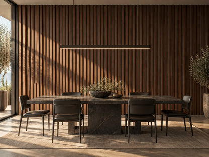 Dining room with walnut grooved wall panels behind a stone dining table